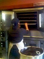 At the bakery - putting cookie sheets in the oven